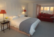 Red double en suite bedroom with sea views